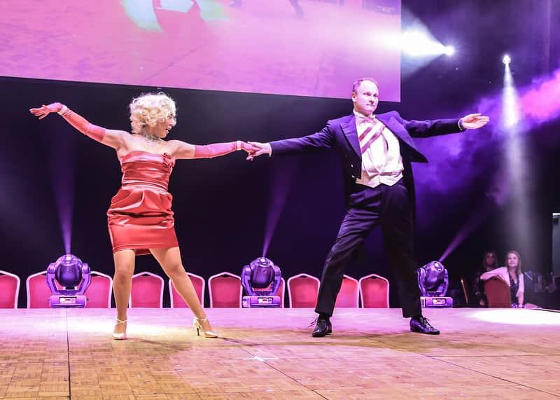 Group of people wearing Stand up to Cancer UK t-shirts.
