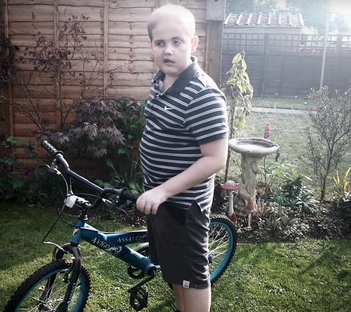 Charlie on his bike in his garden 