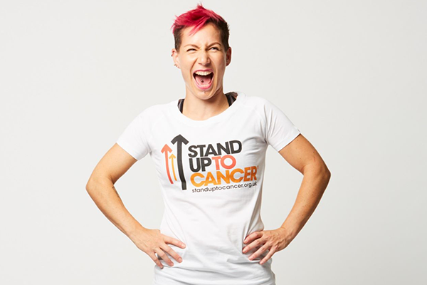 Helen standing up in a Stand Up To Cancer t-shirt