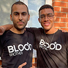 Courtney Wildin and his friend Cameron stood with their arms around each other wearing Blood Brothers t-shirts