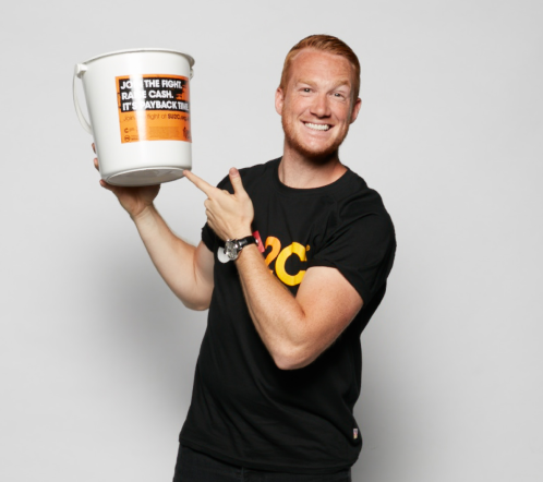 Greg Rutherford holding donation bucket. 