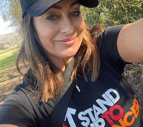 A Stand Up To Cancer supporter in a Stand Up To Cancer t-shirt