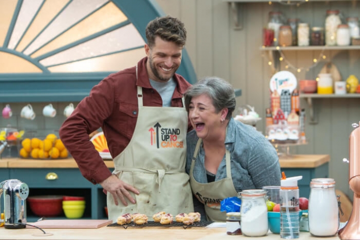 Caroline Quentin and Joel Dommett laughing in the Bake Off tent