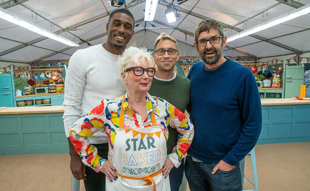 Jenny Eclair in her Star Baker apron with the Bake Off celebrities 