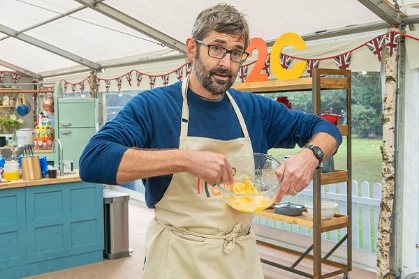 Louis Theroux whisking eggs in the Bake Off tent