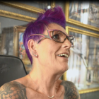 Sue smiling showing mastectomy tattoo