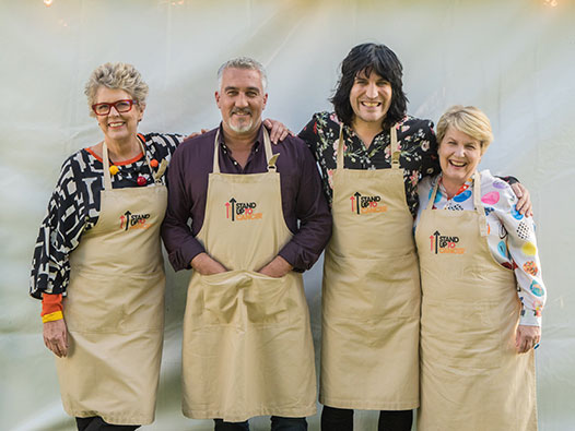 Noel Fielding, Paul Hollywood, Prue Leith and Sandi Toksvig standing outside the Bake Off tent