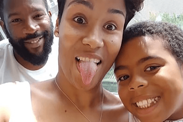 A happy selfie of a young black family: the father, Arron; mother, Cassie; and son, Kye. Cassie is sticking her tongue out at the camera.